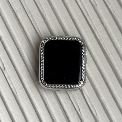 silver rhinestone apple watch case on a textured surface