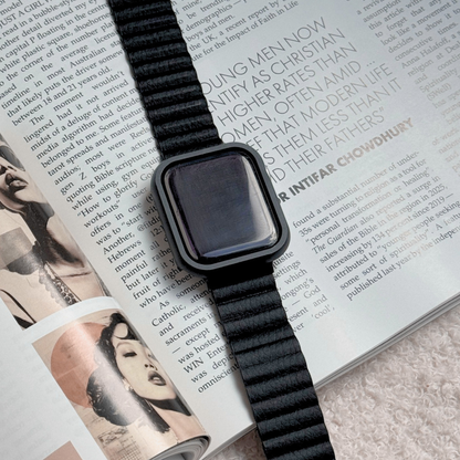 Black stainless steel Apple Watch case cover shown on an open magazine with a matching band. Premium protective bumper, available for Apple Watch 38mm to 49mm, Series 1-11, SE and Ultra