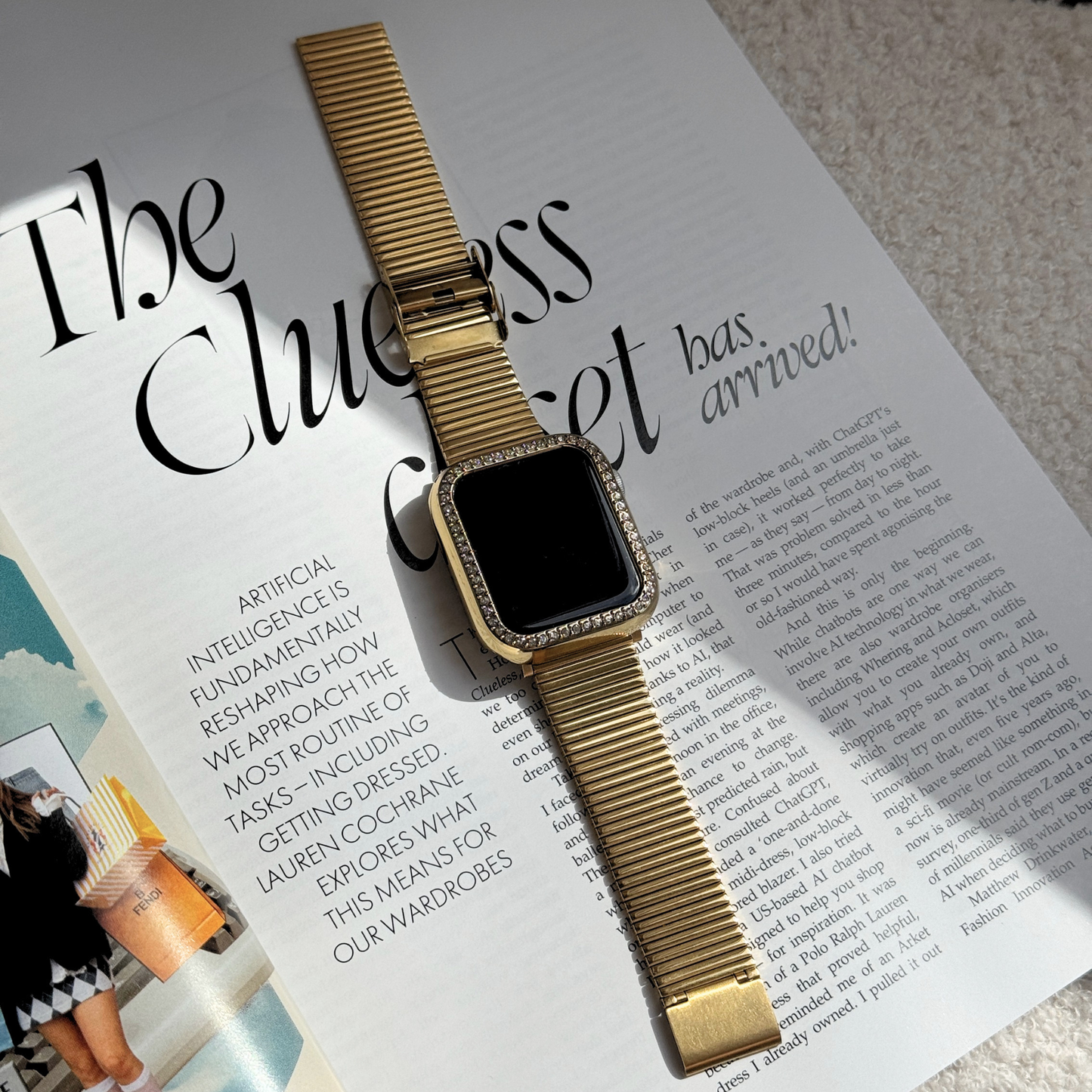 gold apple watch band with a Gold rhinestone apple watch case on a stylish journal/magazine