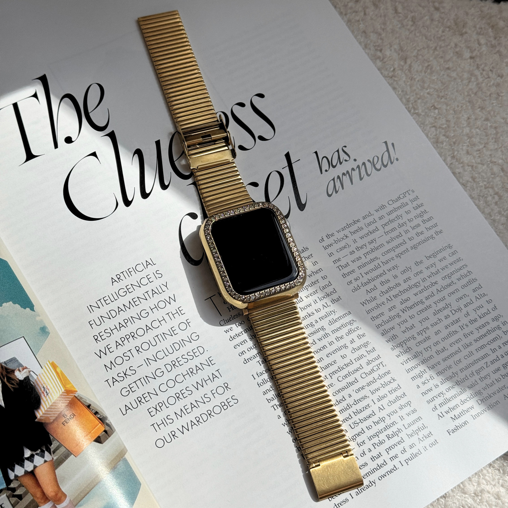 gold apple watch band with a Gold rhinestone apple watch case on a stylish journal/magazine