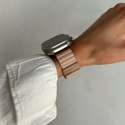 Nude ribbed vegan leather Apple Watch band worn on a wrist with a rolled linen sleeve. Soft magnetic iWatch strap in a neutral tone, compatible with Apple Watch 38mm to 49mm, Series 1-11, SE and Ultra