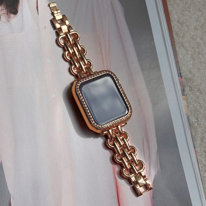 Rose gold chain apple watch bracelet with a rose Gold rhinestone apple watch case on a journal