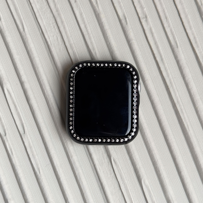 black rhinestone apple watch case on a textured surface