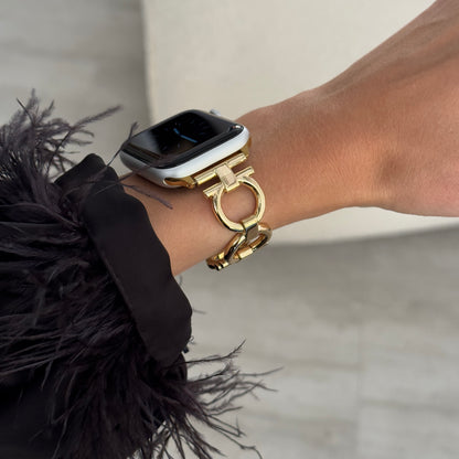 Gold circle link Apple Watch band worn with a feather trimmed cuff. Slim metal iWatch armband, compatible with Apple Watch 38mm to 49mm, Series 1-11, SE and Ultra