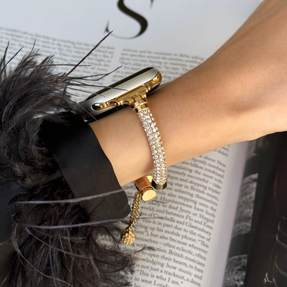 Gold rhinestone Apple Watch band worn on a wrist with a feather trimmed cuff, metal bracelet for Apple Watch 38mm to 49mm