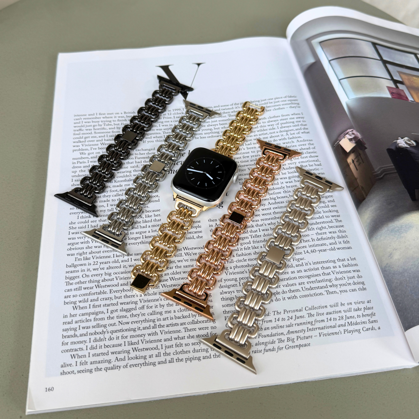 Black, silver, gold, rose gold and starlight open link Apple Watch bands laid out on a magazine. Statement metal iWatch straps for women, compatible with Apple Watch 38mm to 49mm, Series 1-11, SE and Ultra