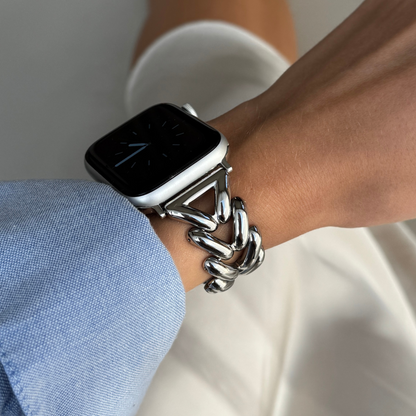 Silver chunky chain Apple Watch band worn on a wrist with a blue shirt cuff. Feminine metal iWatch strap, compatible with Apple Watch 38mm to 49mm, Series 1-11, SE and Ultra