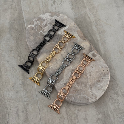 Black, gold, silver and rose gold circle link Apple Watch bands laid on a stone tray. Slim metal iWatch straps and bracelets, compatible with Apple Watch 38mm to 49mm, Series 1-11, SE and Ultra